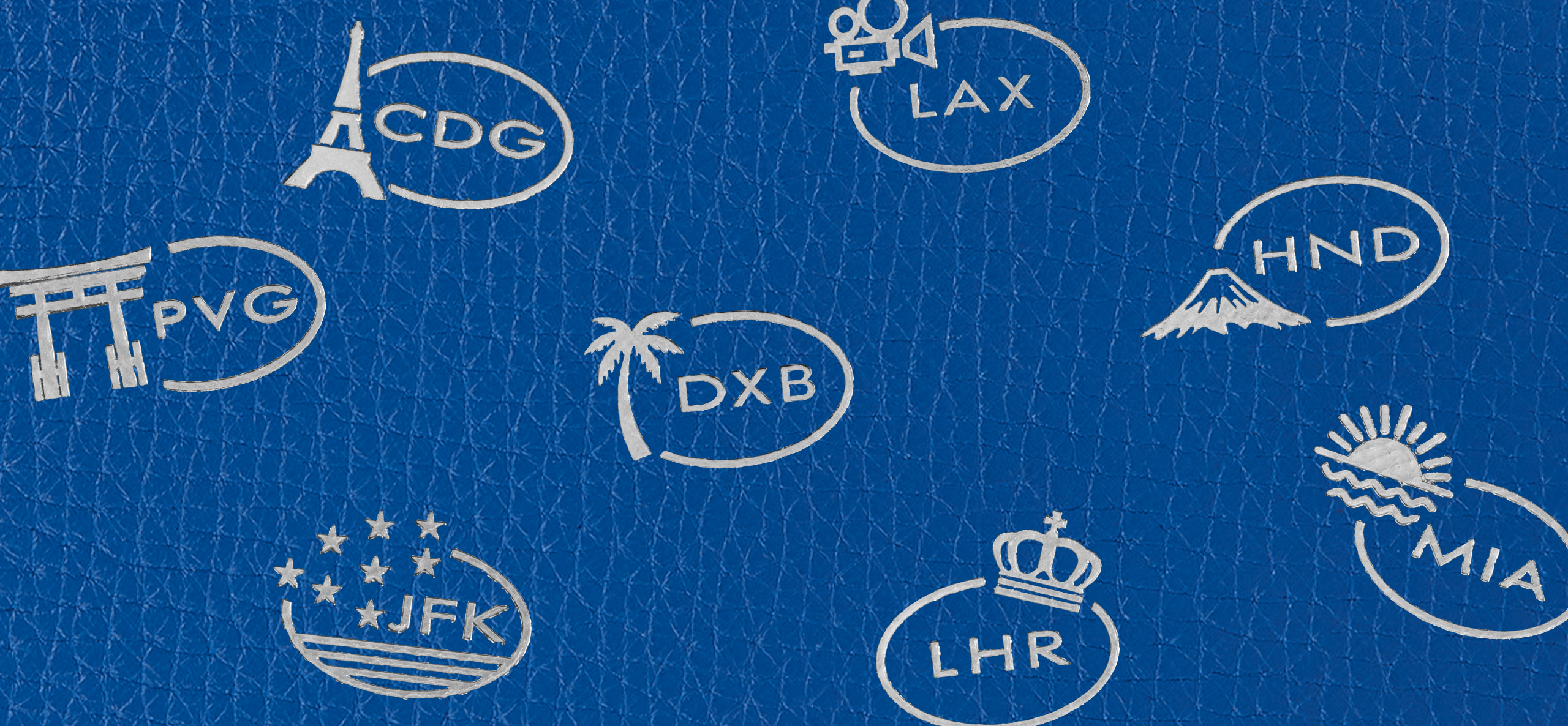Smythson destination motifs embroidered on blue leather
